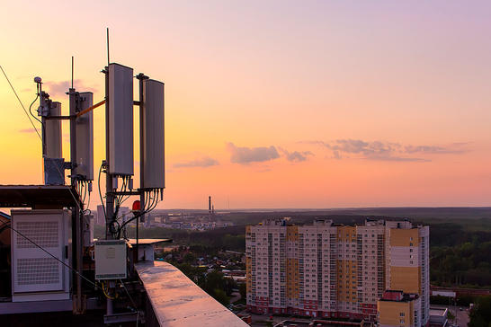 Cell tower on rooftop in urban city