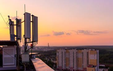 Cell tower on rooftop in urban city