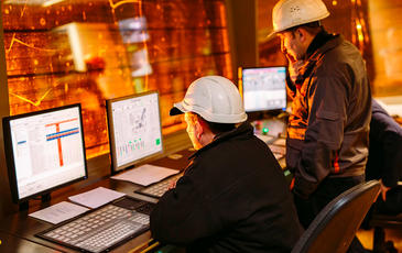 Construction workers looking at computer screens