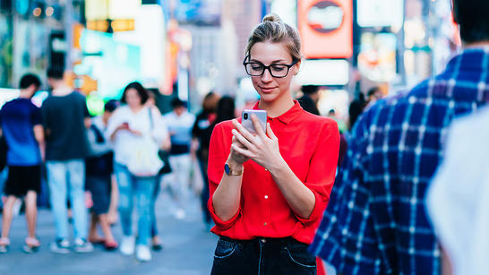 Woman in city looking at her phone