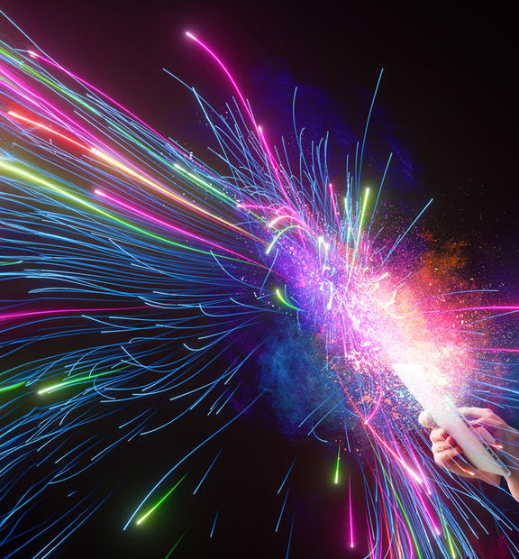 Abstract image of a woman holding a tablet with colorful sparks shooting out from the device