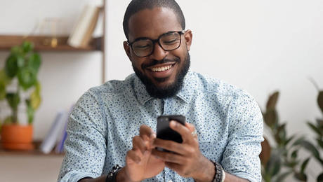 Happy african american businessman using mobile phone